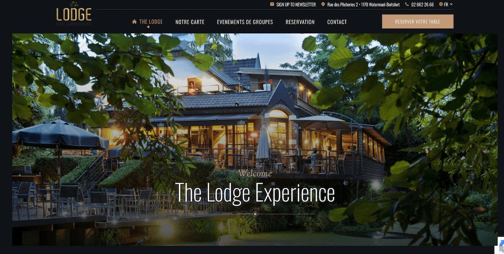 The Lodge Brussels homepage showing the pond-side terrace hero image and restaurant navigation